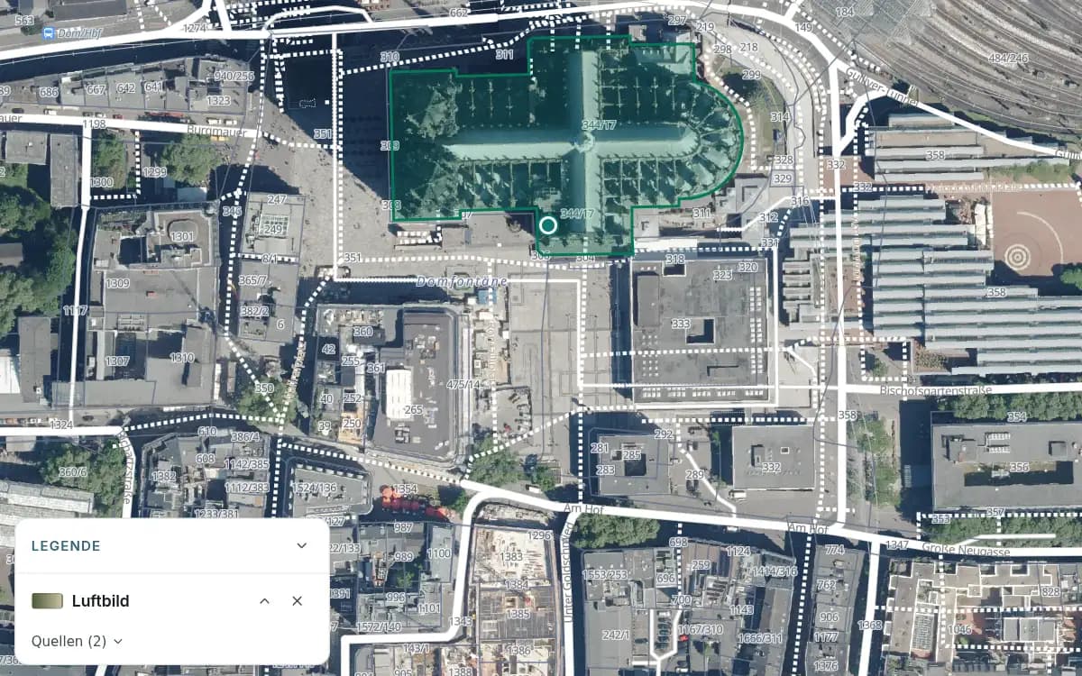 Luftbild von Köln am Dom und Roncalliplatz mit weißen Flurstücksgrenzen und Flurstücksnummern. Eine Stelle am Dom ist markiert, die offene Legende bezeichnet den Hintergrund als „Luftbild“.